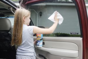 girl washing car window with Armorall